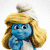 Three blue-skinned Smurf characters with distinct hats and poses, one with long blonde hair, another with a white towel on head, and a third with red hat and white beard, all against white background.