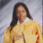 Pixelated static image of a person with long dark hair wearing a yellow garment against a light gray background.