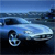 Pixelated blue car with white accents on a dark background, viewed from a low angle with a blurred horizon line.