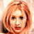 Static pixelated image of a person with light brown hair and red lipstick against a pale background.