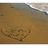 Heart-shaped sand drawing on beach with wave in background, showing subtle pixel changes across frames.