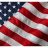 Static pixelated image of a waving American flag with red and white stripes and a blue field of white stars.