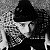 A 50x50 pixel buddy icon split into two sections: a grayscale image of a person on the left and green text on a dark green background on the right.