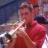 Pixelated static image of a person in red clothing with blurred background and visible dithering artifacts.