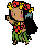 Pixelated character with brown skin, black hair adorned with red and yellow flowers, wearing green outfit with red accents, holding a small object near face.