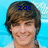 Pixelated portrait of a smiling person with brown hair against a light blue background, featuring blue text above the head.