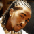 Pixelated static image of a cartoon character's face with brown hair and light skin tones, rendered in low-resolution 256x256 pixels.