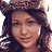 A woman with long dark hair wears a brown fur hat and light-colored bra, smiling while showing her belly button and brown underwear in a of six