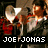 Pixelated image of a person holding an ear drum with text reading 'JOE JONAS' and phrases about blowing out the eardrum.