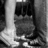 Black-and-white pixelated image of a person's lower body in motion, showing legs and feet with visible clothing folds.