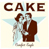 Pixelated static icon showing the word CAKE above a stylized couple with angel wings, rendered in brown and light blue on a pale background.