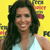 A static pixelated image shows a person with long dark hair wearing a light blue sleeveless top against a bright yellow background with partial colorful text elements.