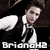 Pixelated image of a person in a black suit with white shirt and tie, holding a white object, with text 'Briangh2' at bottom.