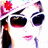 Pixelated image of a stylized face with large dark sunglasses, red lips, and a red flower accessory on the left side.