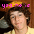 Pixelated image of a person with curly brown hair wearing a yellow shirt, overlaid with pink text reading 'yeo he is' on the left and 'gonster' on the right.