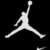 White pixelated silhouette of a basketball player mid-jump on black background, arms extended, one leg forward, one leg back, head tilted upward, right arm raised high, left arm bent at elbow, legs spread wide apart, feet pointed, body angled slightly left, no visible facial features or clothing details, minimal shading, high-contrast monochrome style, cropped to show full figure from head to feet, no text or additional elements present