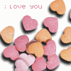 Animated sequence showing four distinct visual states: heart-shaped candies, a black-and-white photo of a shirtless person, and two variations of a birthday cake with lit candles.