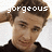 Pixelated image of a person with brown hair wearing a dark shirt, overlaid with white text reading 'gorgeous' across the forehead.