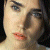 A 50x50 pixel buddy icon split into two frames showing a partial human face on the left and green text on a dark background on the right, with visible pixelation and dithering effects.