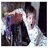 Pixelated image of two figures in close embrace with one figure's arm raised, surrounded by colorful text phrases.