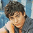 A pixelated image of a person with dark hair resting their head on a hand, next to red text on blue and gray backgrounds.