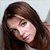 Static pixelated image of a person with long brown hair against light background, likely a celebrity or character reference icon.