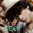 Pixelated image of a person with dark hair and light skin, wearing a white top, with the word "SEXY" in green text at the bottom.