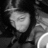 Black-and-white pixelated image of a person with dark hair and a light-colored top, next to red pixelated text reading 'nicole <3' on a black background.