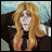 Pixelated image of a character with long orange hair and glasses, wearing a dark outfit with purple and orange accents, against a blurred outdoor background.