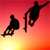 Pixelated static icon showing two black silhouettes against a red-to-yellow gradient background, one figure seated on a skateboard and another performing a trick mid-air with arms outstretched.