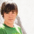 A pixelated image of a person with brown hair wearing a green shirt, positioned next to text on colored backgrounds.
