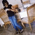 Pixelated static image shows a figure in dark top and blue pants against blurred background with light patches.