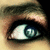 A close-up of a human eye with blue irises showing subtle variations in pupil position across four