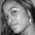 Black-and-white pixelated image of a person's face in profile view with visible hair and ear, cropped closely to the head.