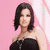 A woman in a black strapless dress poses against a pink background with a white curtain, while a separate section displays blue text on a patterned surface.