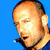 Static pixelated image of a person's head and shoulders against solid blue background with visible dithering and color banding in skin tones.
