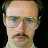 Four identical pixelated headshots of a man with glasses and a mustache arranged in a , each with a single white letter in the corner