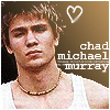Pixelated portrait of a person with tousled brown hair wearing a white tank top and beaded necklace, with a white heart outline and text reading 'chad michael murray' on a gradient brown background.