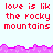 Red pixelated text 'love is like the rocky mountains' repeats across a light blue background with pink jagged borders.