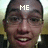Pixelated close-up of a person's face with 'ME' text overlaid on the forehead, wearing a dark jacket and light-colored shirt, against a blurred background.