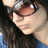 A pixelated close-up of a person with long dark hair wearing a blue top, showing two sequential facial expressions with eyes closed and mouth slightly open.