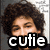 Pixelated image of a person with curly brown hair and closed eyes, overlaid with bold white text reading 'cutie' on black background.