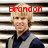 A pixelated image of a person with blonde hair wearing a dark blue shirt under a light gray jacket, standing against horizontal striped background.