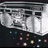 Pixelated static image of a silver and black vehicle with white accents, viewed from above against dark background.
