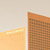 A static image showing a partial view of a building with a brick facade and a light-colored wall, with a bright yellow section on the left side.