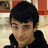 A pixelated image of a person with dark hair wearing a black hoodie, with blue text overlays reading 'GregDiTullio' and 'Get Well Soon!' against a blurred background.