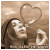 A person with long brown hair holds a transparent heart-shaped balloon while looking upward, with text at the bottom reading "YOU BLEW ME AWAY".