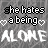A static image displays repeated text "she hates a being" with heart symbols above and the word "ALONE" below, all in white pixelated font on a gray background.