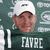 Pixelated image of a person wearing white cap and dark green jersey with 'DUNCE' text, set against blurred background.