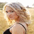 A pixelated image of a woman with blonde hair in an outdoor setting, alongside multiple heart-shaped icons and partial text fragments.